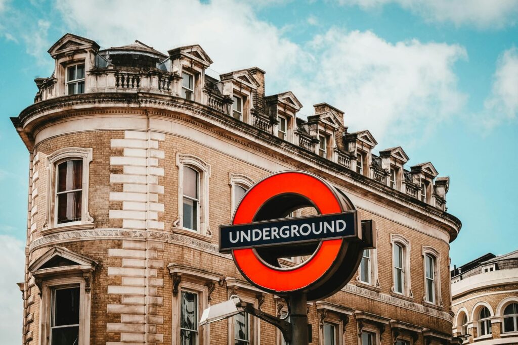 London underground sign outside a brick building against a blue sky