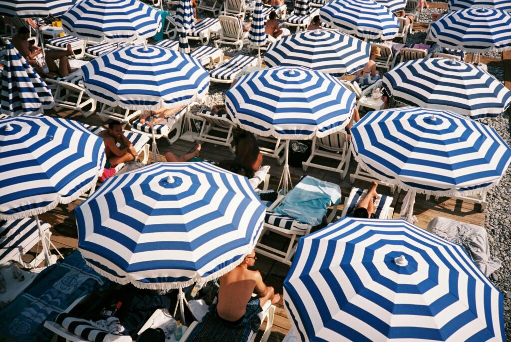 French Riviera: blue and white striped beach umbrellas from above